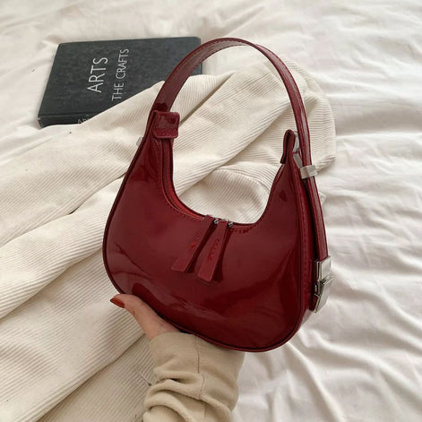 Schultertasche in Halbmondform mit verstellbarem Gurt und Reißverschlusstaschen